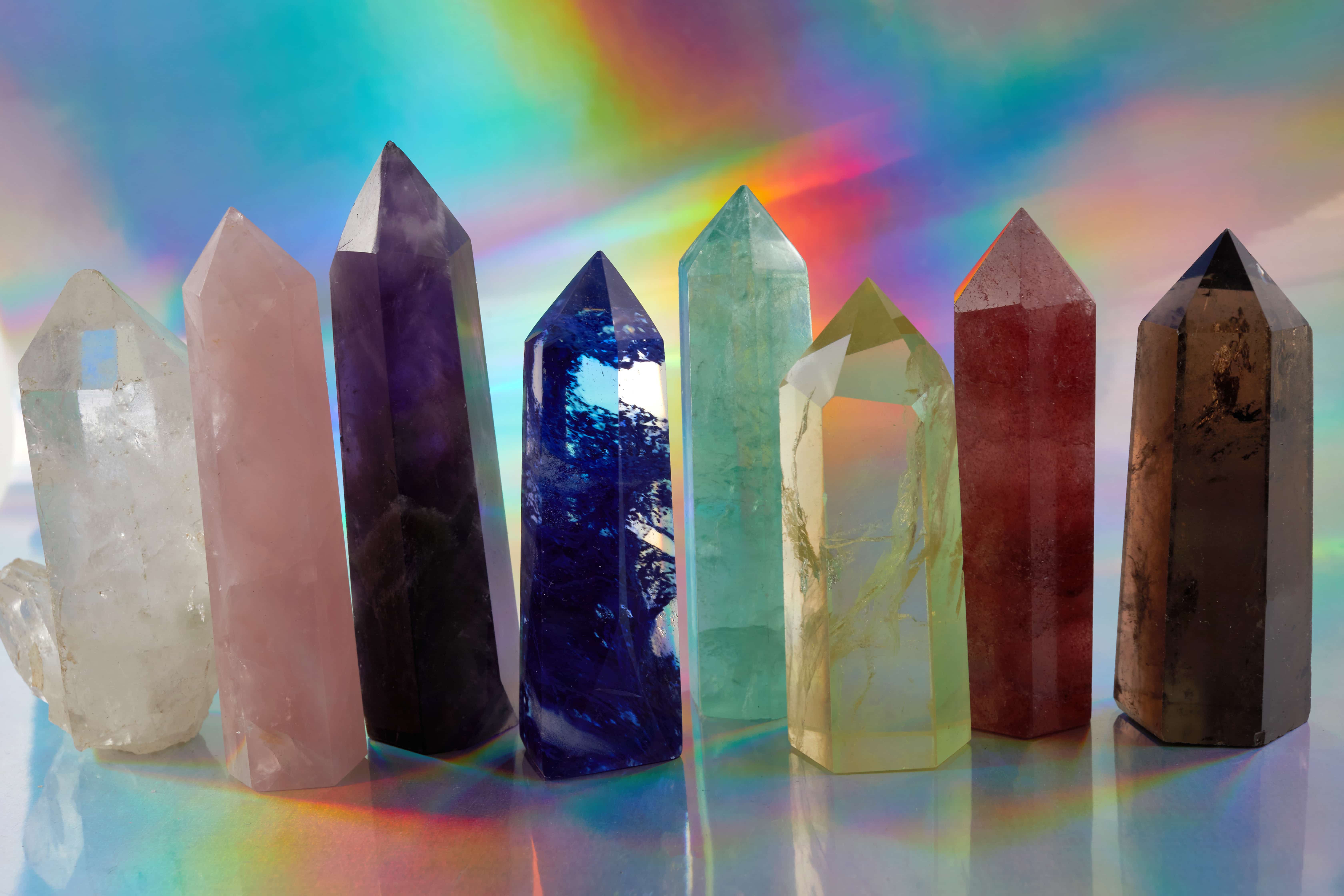 Eight reiki crystals side by side in multiple colors.